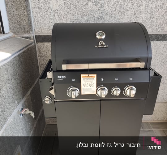 גריל גז שחור על רקע קיר אבן